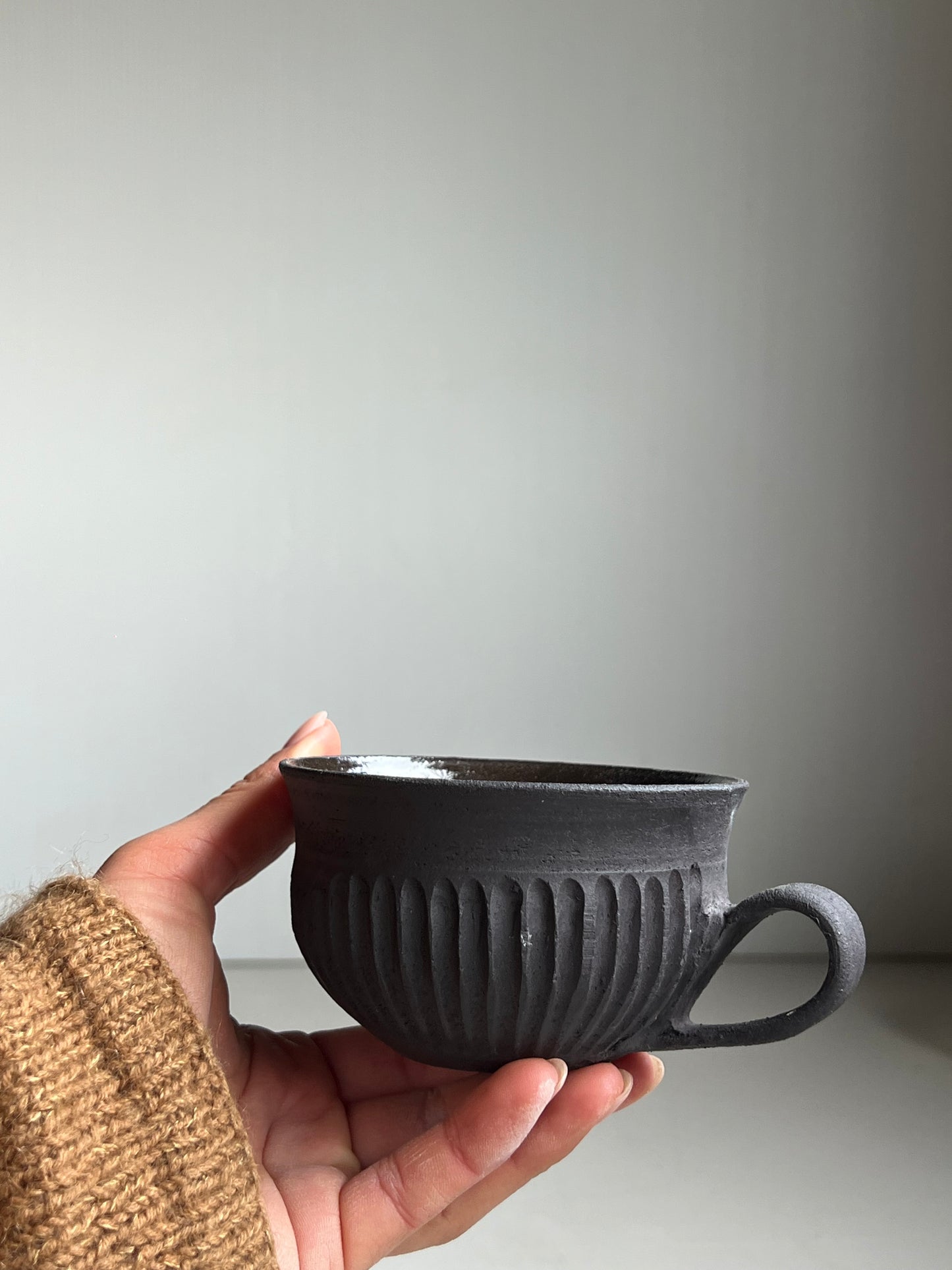 Black Clay fluted cup unglazed outside